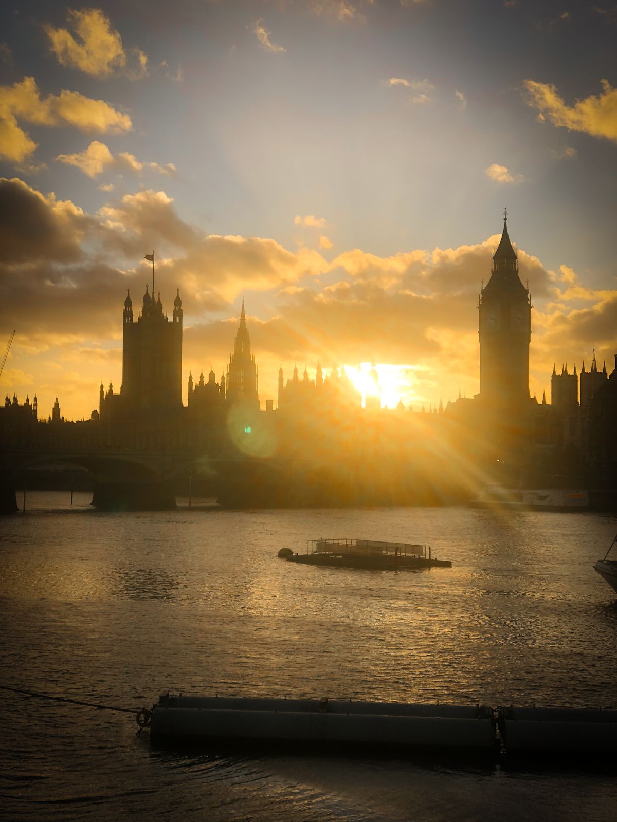 The Palace of Westminster at sunset, seen across the Thames.
